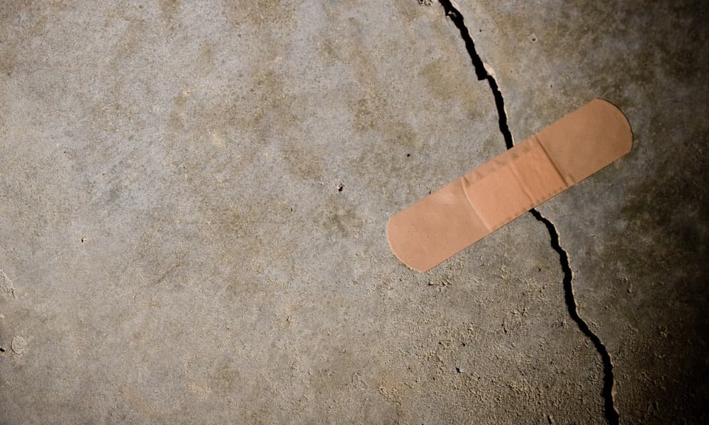 Representation of concrete repair with bandage on wall.