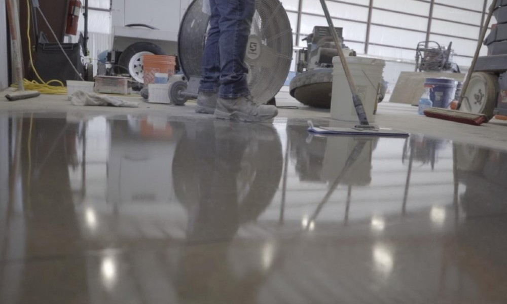 A Concreate worker polishing a concrete floor.