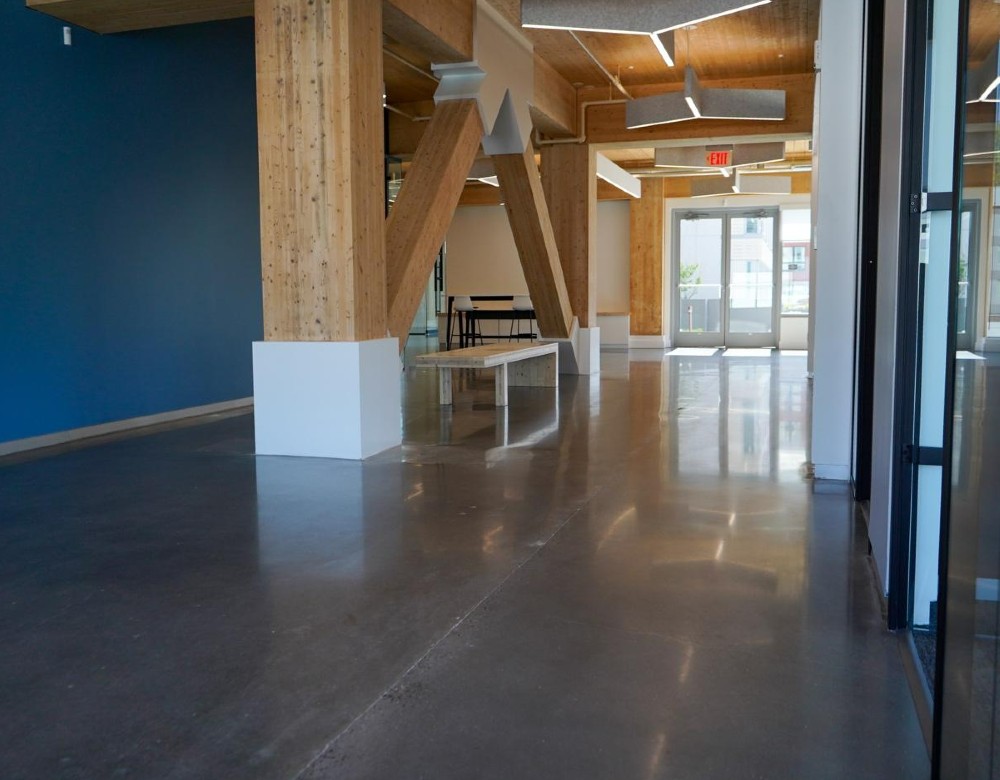 A polished concrete floor in an open office building space.