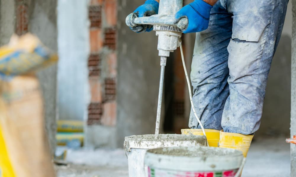 A concrete contractor mixing grout to apply on polished concrete.